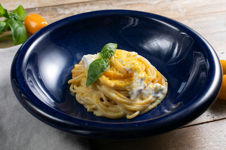 Pasta with yellow cherry tomatoes, stracciatella and bottarga