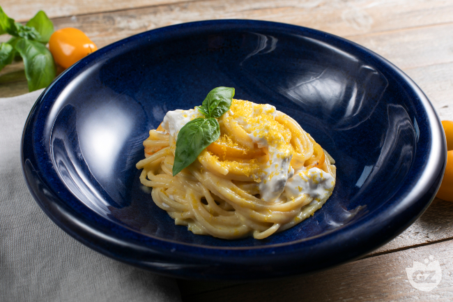 Spaghetti with yellow cherry tomatoes, stracciatella and bottarga